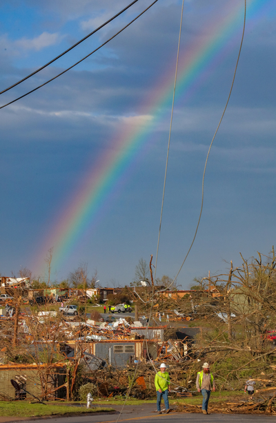 A rainbow arcs over storm damage along Shackleford Road as employees of Summit Energy worked to turn off damaged gas lines. A tornado plowed through west Little Rock Friday, March 31, 2023, damaging hundreds of homes and businesses. (John Sykes/Arkansas Advocate)