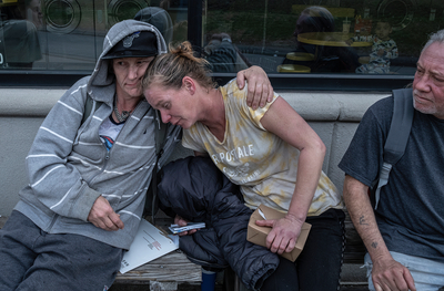 Misty Caudill, left, hugs Bobbie Dolan, center, who has no where to live. Edward Robinson, who is also homeless, looks on. Metro closed the homeless camps near Harding Place and Edmonson Pike which displaced many people. (Photo: John Partipilo)