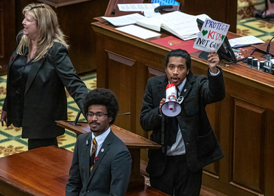 Reps. Justin Jones, right, Justin Pearson, bottom, and Gloria Johnson, left, bring a megaphone onto the Tennessee House floor on March 30, 2023. (Photo: John Partipilo)
