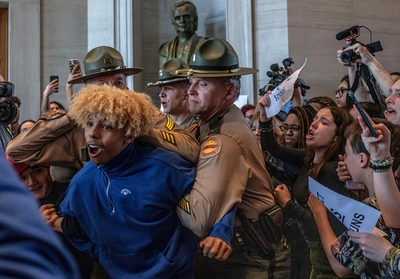 Tennessee Highway Patrol officers subdue a Nashville high school student during a gun safety protest at the Capitol on Thursday. The student had attempted to follow lawmakers into a bathroom. (Photo: John Partipilo)